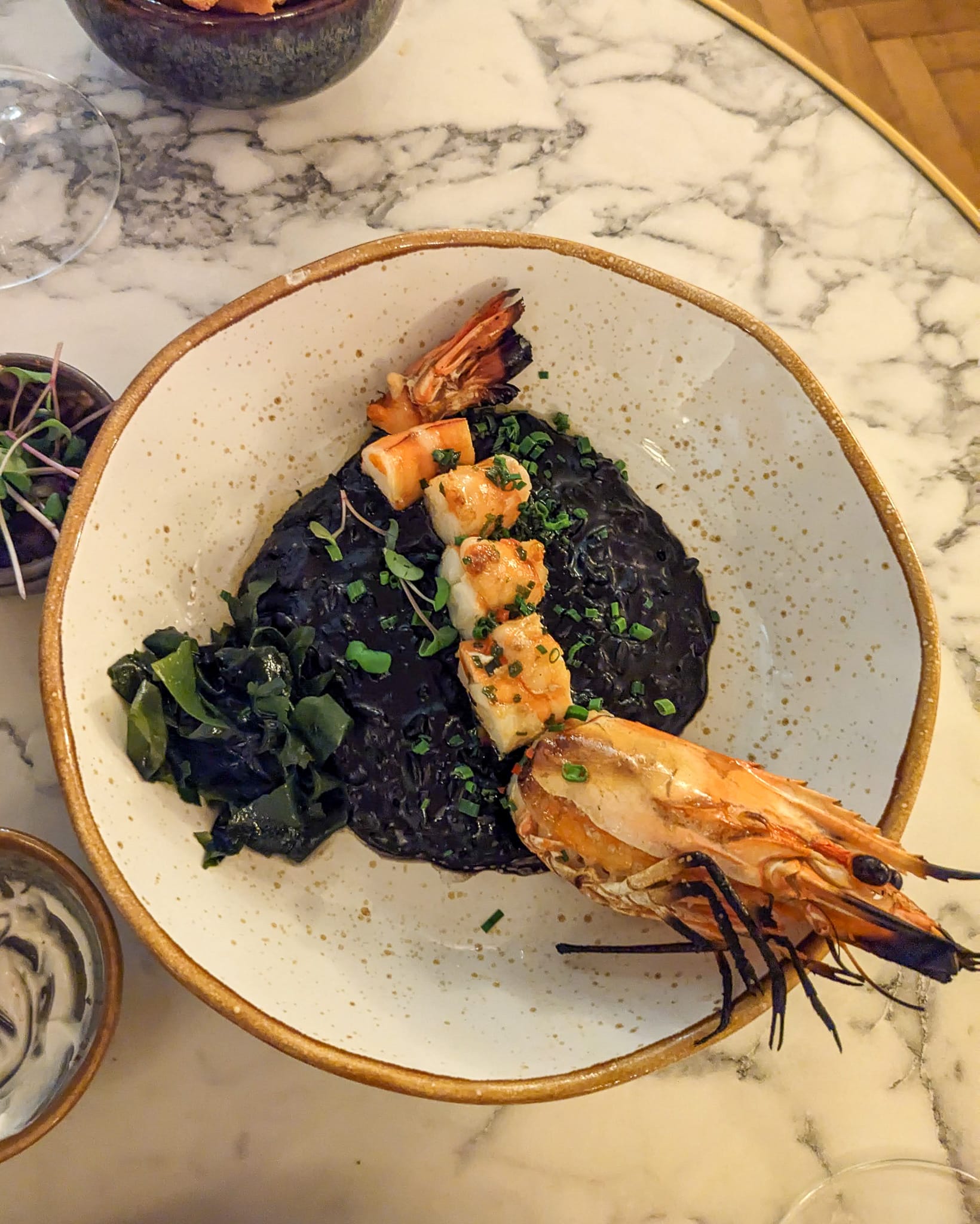 Grilled tiger prawn, cuttlefish risotto and seaweed